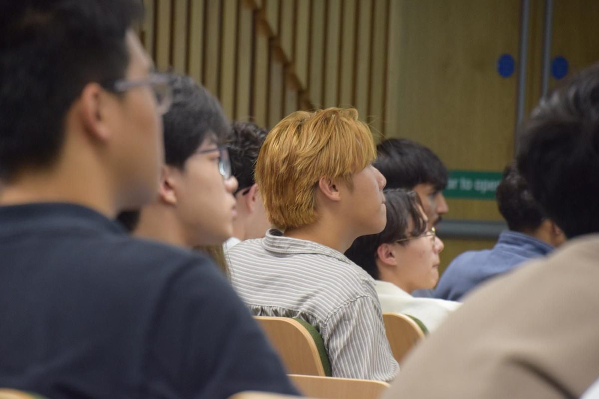 Students listening during a society session in a UCL lecture theatre.